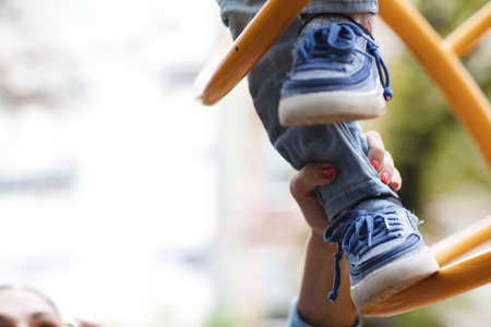 Little disabled girl plays on the playgroundの写真素材