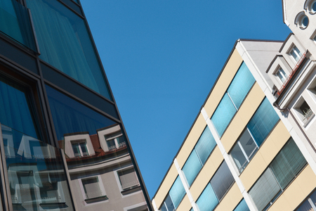 Urban futuristic architecture, reflections in windows and blue sky backgroundの写真素材
