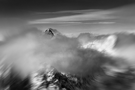 Black and white view of moving clouds around mountain summit in High Tatras. Slovakia, Eastern Europe. Mengusovsky stitの写真素材