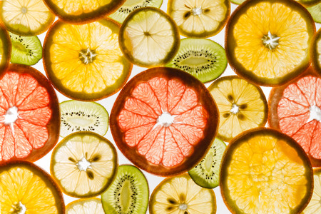 Transparency sliced fruits on white background. Rings of grapefruit, kiwi, lemon and orangeの写真素材