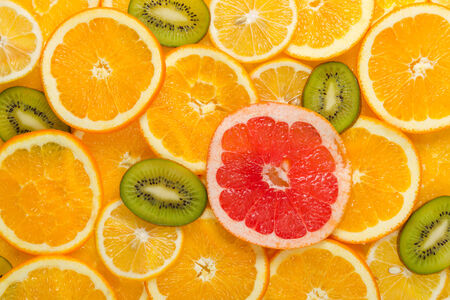 Sliced healthy fresh fruits. Rings of grapefruit, kiwi, lemon and orangeの写真素材