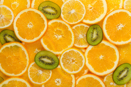 Sliced healthy fresh fruits. Rings of grapefruit, kiwi, lemon and orangeの写真素材
