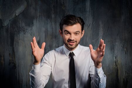 Portrait of businessman with expression emotion and hands on sidesの写真素材