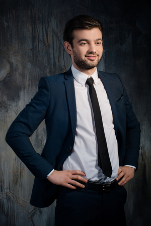 Portrait of successful and happy businessman looking awayの写真素材