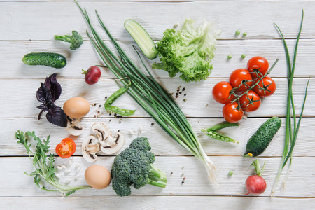 Fresh vegetarian variety on white rustic wooden background, top viewの写真素材