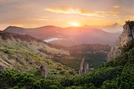 Panoramic view of unique mountain landscape on sunset with big rocks on foregroundの写真素材