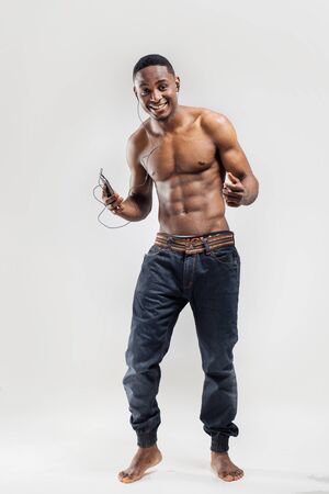Handsome African American man listening music on his mobile device after sport exerciseの写真素材