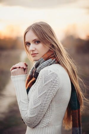Portrait of beautiful sad woman in autumn season. Soft sunny colorsの写真素材