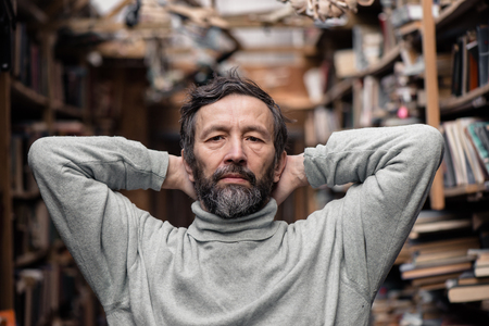 Portrait of authentic senior man with beard and mustache on book marketの写真素材