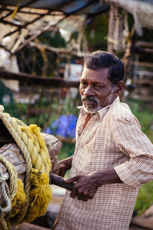 Kochi, India - November 29, 2015: Traditional technology of fishing. Fisherman hardly working on Chinese fishing net on the sea beach in Fort Kochi Cochin, Kerala, India.のeditorial素材