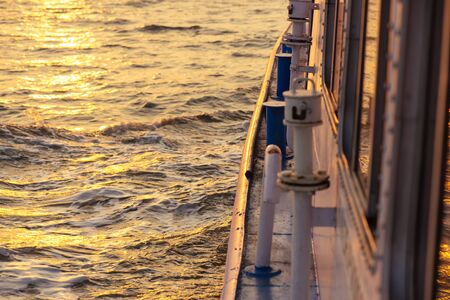 Beautiful sunset and gold water from ferry boat in open seaの写真素材