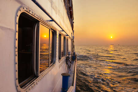Beautiful gold sunset from ferry boat in open sea