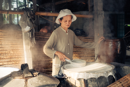 Can Tho, Vietnam - April 2, 2016: Senior woman working on homemade rice macaroni factory in Vietnamのeditorial素材