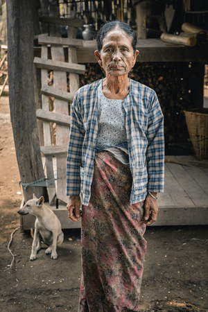 Pan Paung, Myanmar - May 30, 2016: Tattooed woman from Chin state stand near own house, Mrauk U regionのeditorial素材
