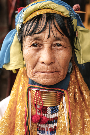 Loikaw, Myanmar - May 25, 2016: Portrait of Padaung (Karen) long neck woman in brass rings around their neck and traditional clothing on the Deenawso marketのeditorial素材