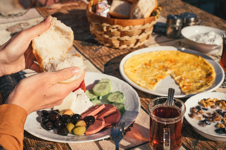 Traditional turkish food on breakfast from omelet, tea, olives, cheese and breadの写真素材