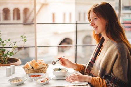 Young woman eat and enjoy tasty traditional  turkish food from lentil soupの写真素材