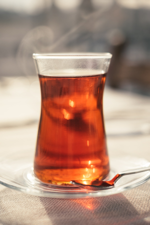 Traditional turkish drink of tea on white table with blurred backgroundの写真素材