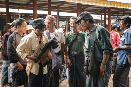 Loikaw, Myanmar - May 25, 2016: Traditional scene on Deenawso market in Myanmar. Group of people bargaining and selling hunted wild animalsのeditorial素材