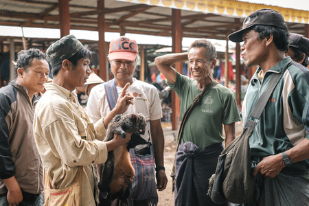 Loikaw, Myanmar - May 25, 2016: Traditional scene on Deenawso market in Myanmar. Group of people bargaining and selling hunted wild animalsのeditorial素材