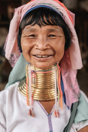 Loikaw, Myanmar - May 25, 2016: Portrait of Padaung (Karen) long neck woman in brass rings around their neck and traditional clothing on the Deenawso marketのeditorial素材