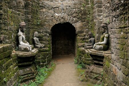 Tunnel with ancient ruins of Buddha statues in Kothaung Paya temple in Mrauk-U city, Rakhine state, Myanmarの写真素材