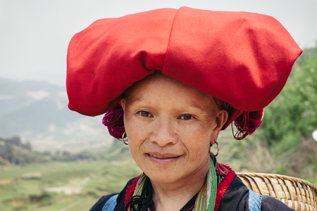 Sapa, Vietnam - April 14, 2016: Vietnamese woman portrait outdoors in village near Sapa. Red Dzao Hmong minority woman in traditional clothesのeditorial素材