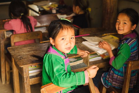 Sapa, Vietnam - April 14, 2016: Vietnamese school children in the rural junior classroom. Education in the small village near Sapa for Hmong minority kids.のeditorial素材