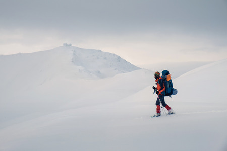 Tourist enjoying beautiful landscape and feel freedom in winter mountain at sunset. Winter sport activityの写真素材