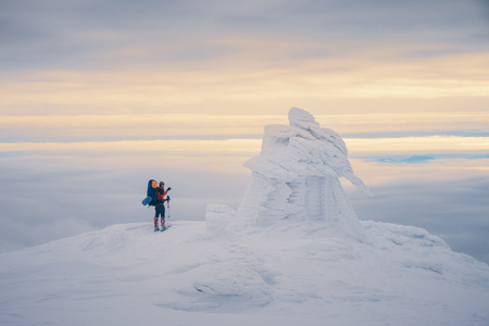 Tourist enjoying beautiful landscape and feel freedom in winter mountain at sunset. Winter sport activityの写真素材