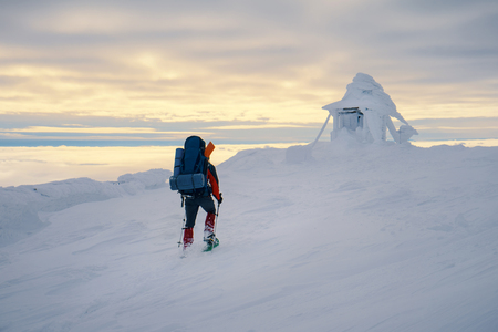 Tourist enjoying beautiful landscape and feel freedom in winter mountain at sunset. Winter sport activityの写真素材