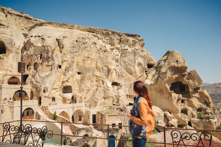 Urgup, Turkey - April 11, 2017: Traveler standing on terrace looking at the panorama of cave houses on a sunny day in Urgupのeditorial素材
