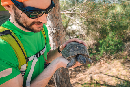 Male traveler getting to know local fauna on a sunny day in Turkey.の写真素材