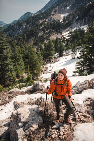 Smiling hiker trekking up the mountain on a sunny day in Turkey. Shot from above.の写真素材