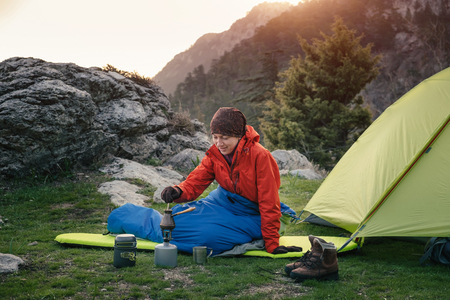 Traveler making coffee in cezve on a gas burner in the mountains in Turkeyの写真素材