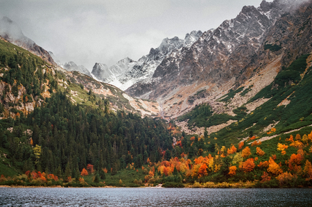 Mountain landscape of Popradske pleso with High Tatras in background on a sunny day in Autumn, Slovakia. Shot with film camera and grainの写真素材