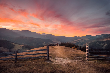 Beautiful pink and golden sunset in autumn mountain landscapeの写真素材