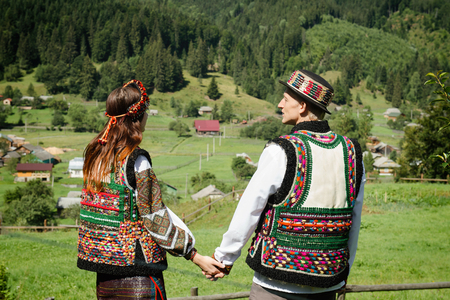 Young couple in ethnic and traditional Ukrainian clothes in the Carpathian mountainsの写真素材