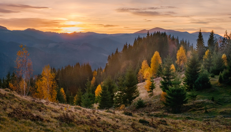 Beautiful golden sunrise in autumn mountain landscapeの写真素材