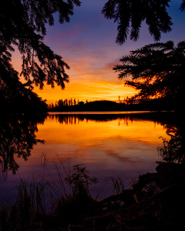 Breathtaking Gold sunset at Strbske mountain lake with its reflections in Autumn, High Tatras in the backgroundの写真素材