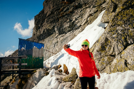 Woman hiker take selfie near unique mountain altitude toilet. Travel destination scenes in High tatras mountain in slovakiaの写真素材