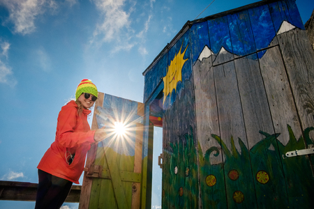 Woman hiker happy landscape near unique mountain altitude toilet. Travel destination scenes in High tatras mountain in Slovakiaの写真素材