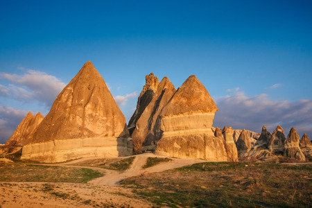 Colorful Rose valley mountain with blue sky in Cappadocia landscape at sunset, Red canyon in Goreme village, Turkeyの写真素材
