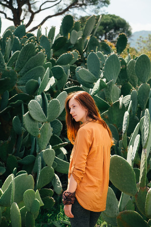 Dreamy woman walking in desert cacti plant and enjoying the natureの写真素材