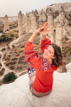 Beautiful woman enjoying amazing view of love valley canyon in Cappadocia landscape. Travel in Turkeyの写真素材