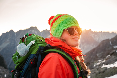 Young hiker in colorful fantastic mountain landscape near prayer flags at gold sunset under Rysy in High Tatras, Slovakiaの写真素材