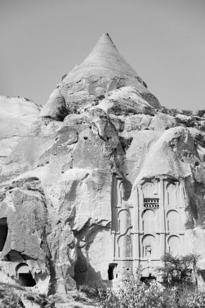 Beautiful black and white mountain landscape in Cappadocia Rose valley with cave house and ancient church ruins, Turkey, Goremeの写真素材