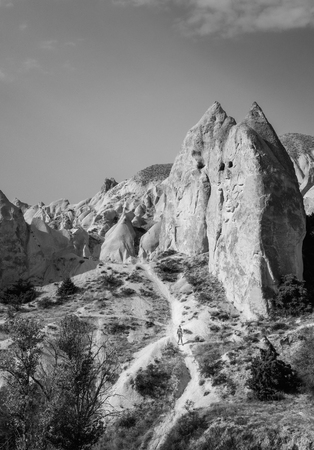Beautiful black and white mountain landscape in Cappadocia Rose valley with cave house and ancient church ruins, Turkey, Goremeの写真素材