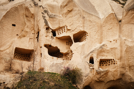Ruined and ancient cave house in Cappadocia mountain landscape. Travel in Turkeyの写真素材