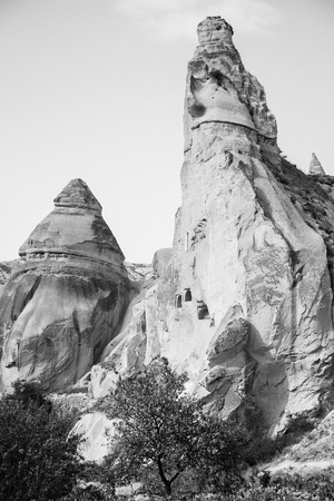 Beautiful black and white mountain landscape in Cappadocia Rose valley with cave house and ancient church ruins, Turkey, Goremeの写真素材